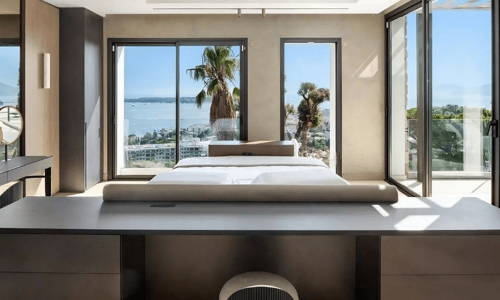 Villa Hotel Bassa Californie in Cannes, French Riviera, France – outdoor lounge terrace with wicker chairs and coastal backdrop